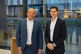 Two person staying in a foyer of a business building